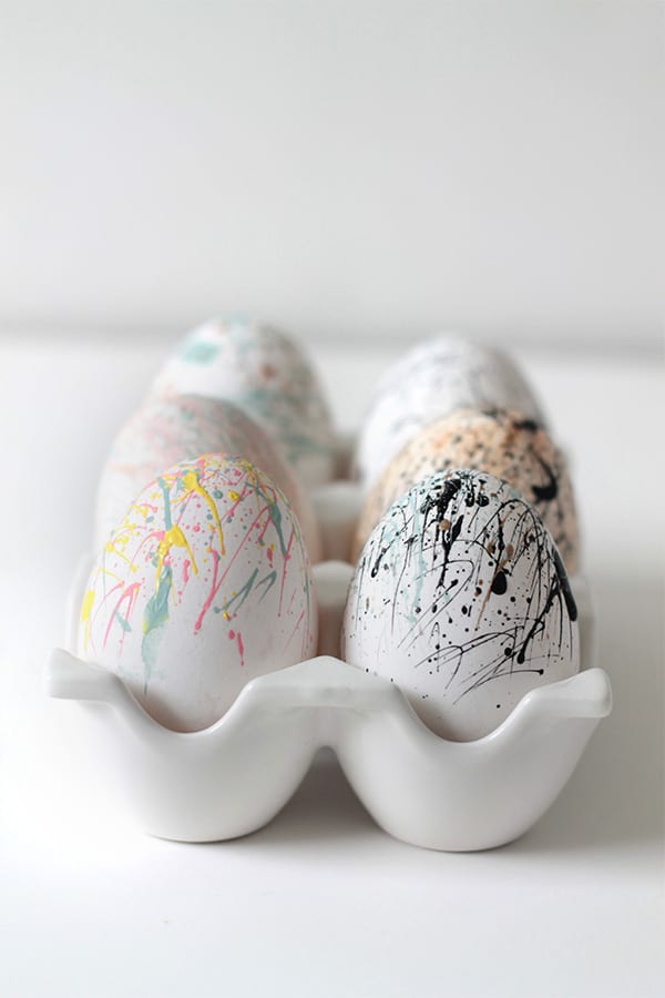 paint splattered eggs in egg holder tray