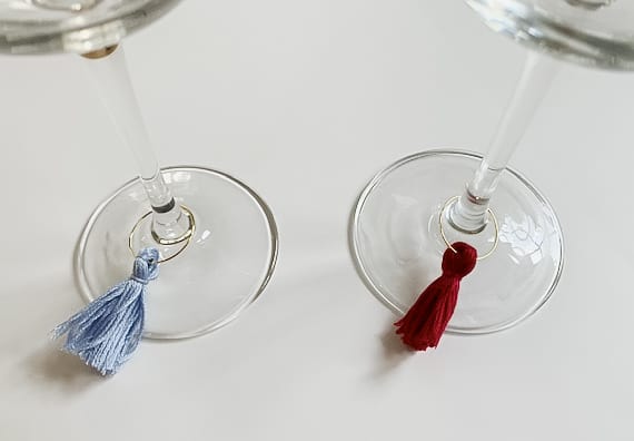 2 wine glasses with tassel wine charms.