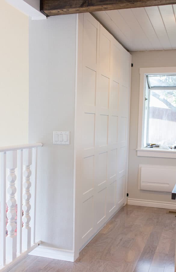 Tall white pantry wall units.