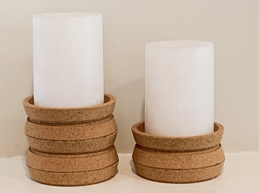 2 cork candlesticks with candles made from IKEA Cork coasters.