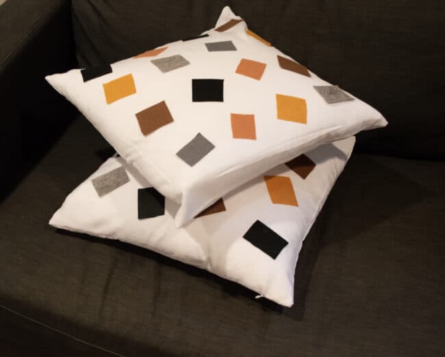 white cushion with colored felt squares