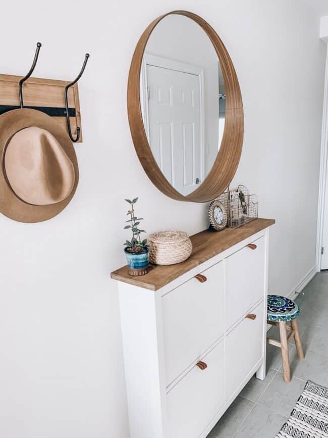 Brown and white IKEA Hemnes shoe storage unit.