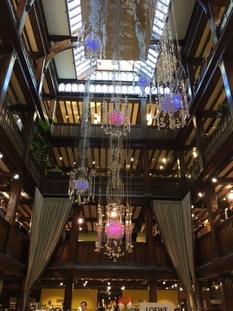 Atrium inside Liberty's of London, with chandeliers.