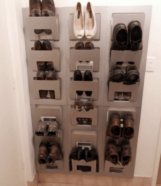 wall mounted magazine racks storing shoes.