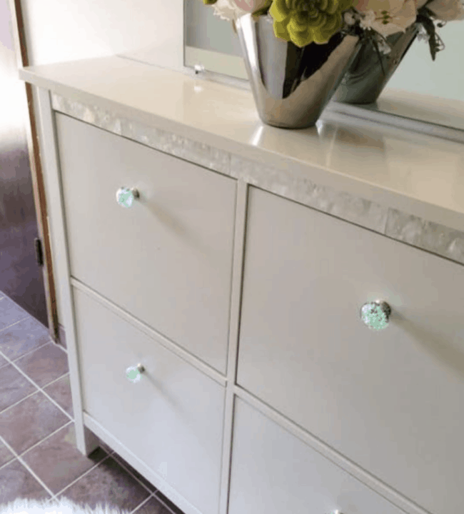 White Hemnes shoe storage unit with mother of pearl strip.