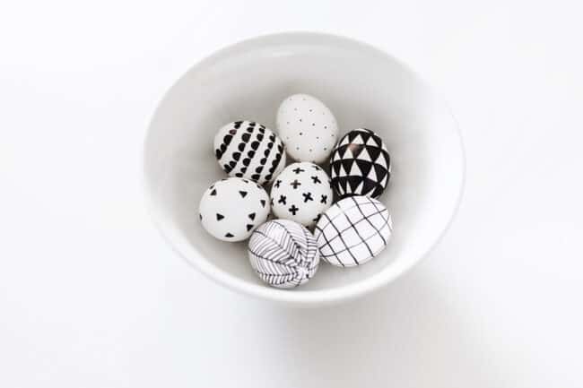 Bowl of black and white decorated eggs.