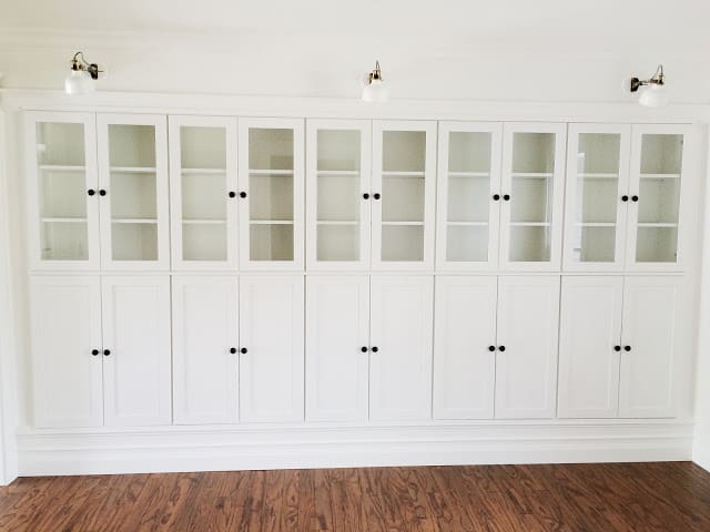 Tall white built-in wall bookcases.